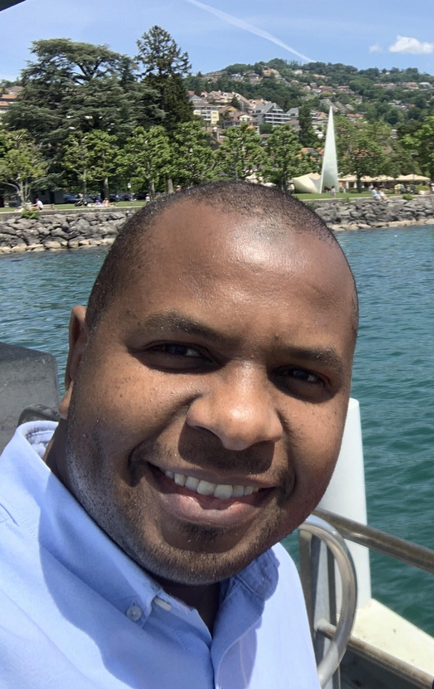 Person smiling with lake background